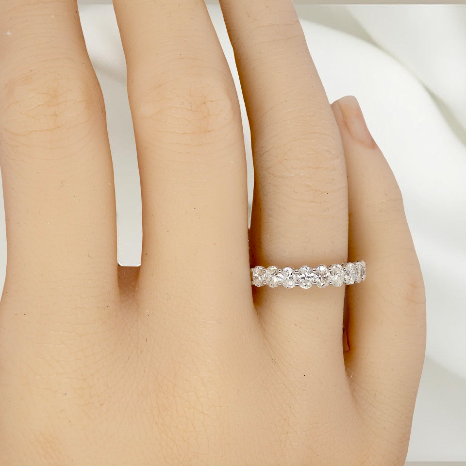 hand gorgeous half-hoop eternity ring set with nine oval brilliant-cut white diamonds.
