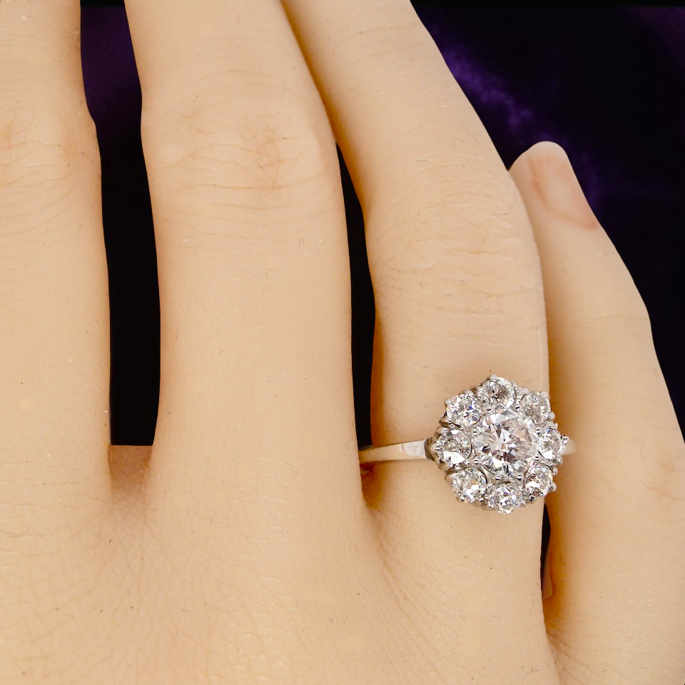 hand gorgeous vintage cluster ring that has as its principal setting an old brilliant cut white diamond,