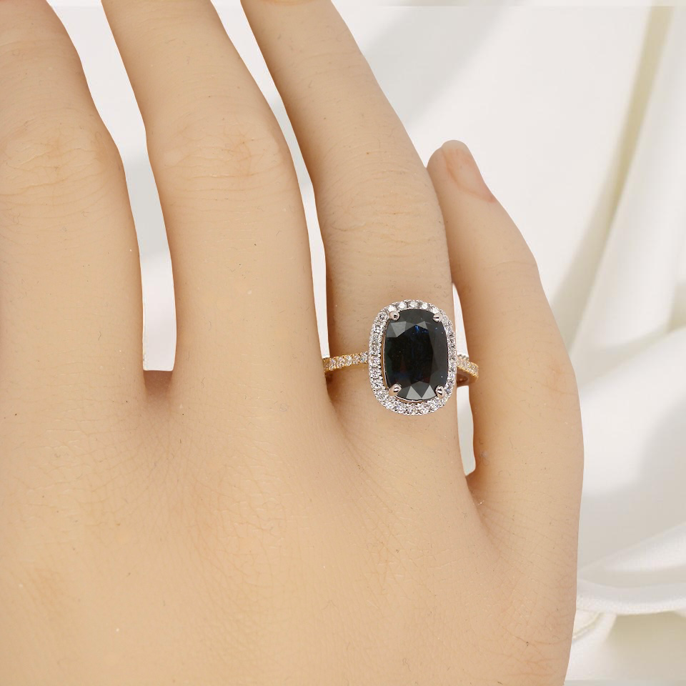 hand striking cluster ring featuring a captivating ink-black blue sapphire,