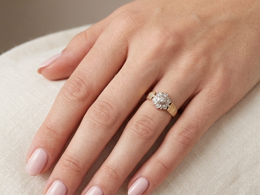 typical design from the 1960s/1970s era, a daisy cluster set with brilliant cut white diamonds a