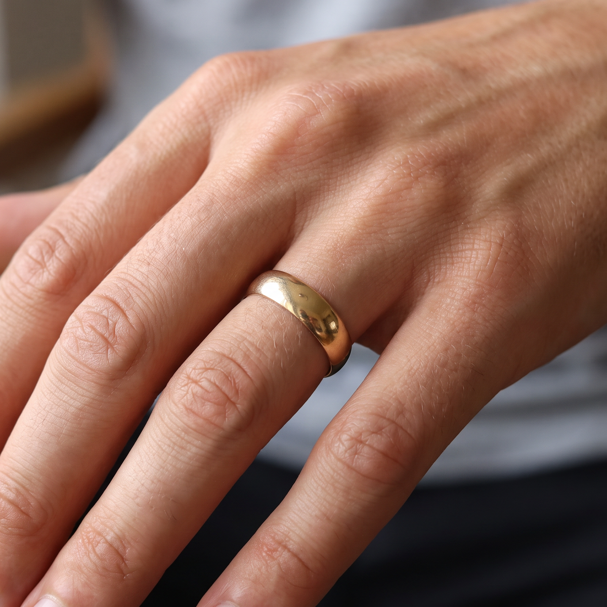 hand A traditional wedding ring. 9 carat gold and suitable as a ring for a man. Width 7.5mm, D shape profile.