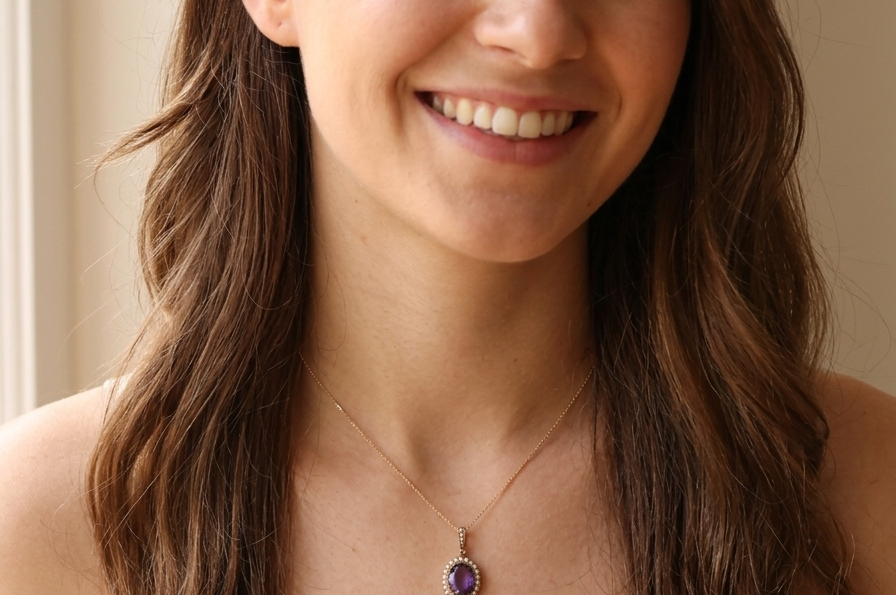 model A fine 15 carat gold* pendant. features a large amethyst centre stone 14x11mm, deep purple colour.