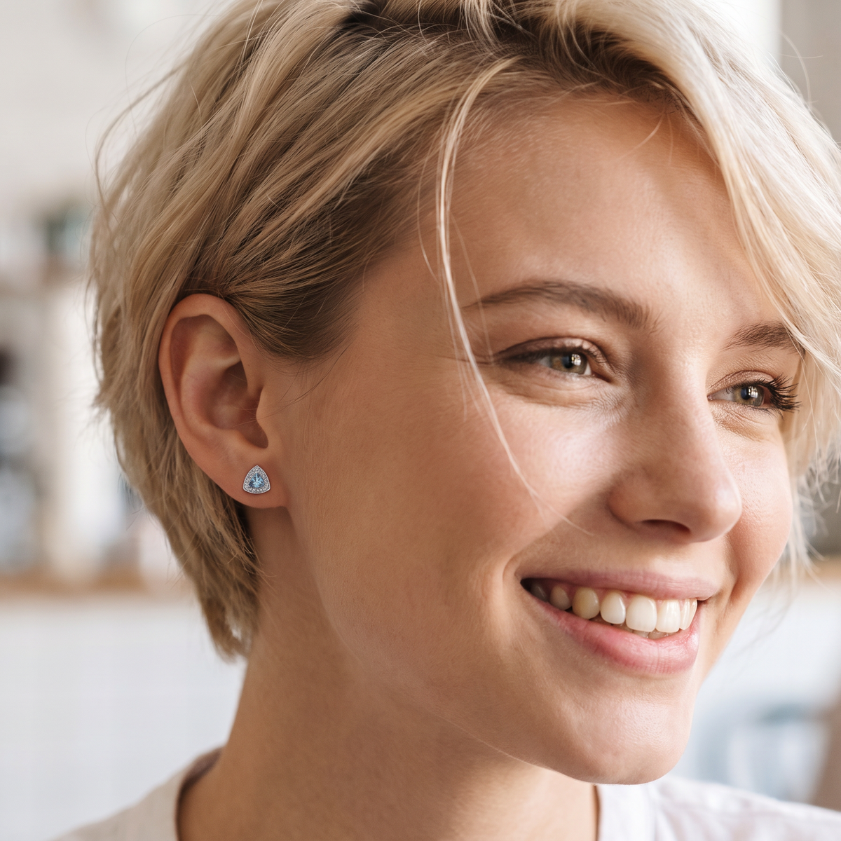 model 18 carat white gold cluster earring, each containing a trapeze cut aquamarine 6x6x6mm (1 carat) surrounded by eighteen x 0.02 carat brilliant cut white diamonds.