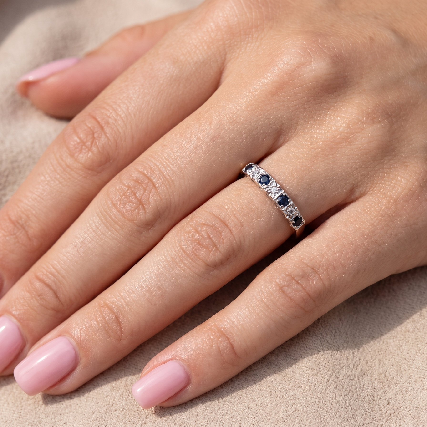 model A 9 carat gold half hoop eternity ring. Set with four sapphires, each 2.4mm, and between each a 1mm illusion set diamond.