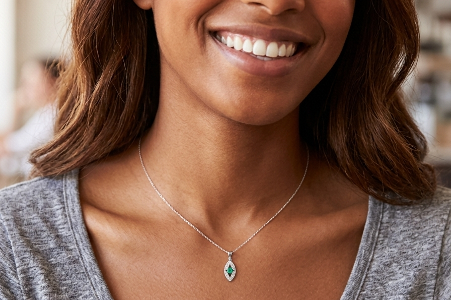 model A beautiful modern 18ct white gold pendant featuring a cushion-cut emerald measuring approximately 4 x 3.5mm (estimated 0.35 carat), displaying a rich deep grass-green hue.