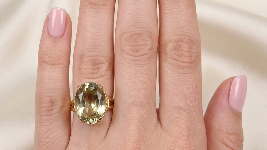 model A continental dress ring that tests as 18 carat gold. Features a large citrine gemstone, that measures 18x13mm, depth 9mm. Golden yellow with a hint of olive green. 
