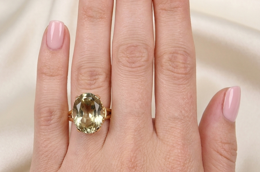 model A continental dress ring that tests as 18 carat gold. Features a large citrine gemstone, that measures 18x13mm, depth 9mm. Golden yellow with a hint of olive green. 
