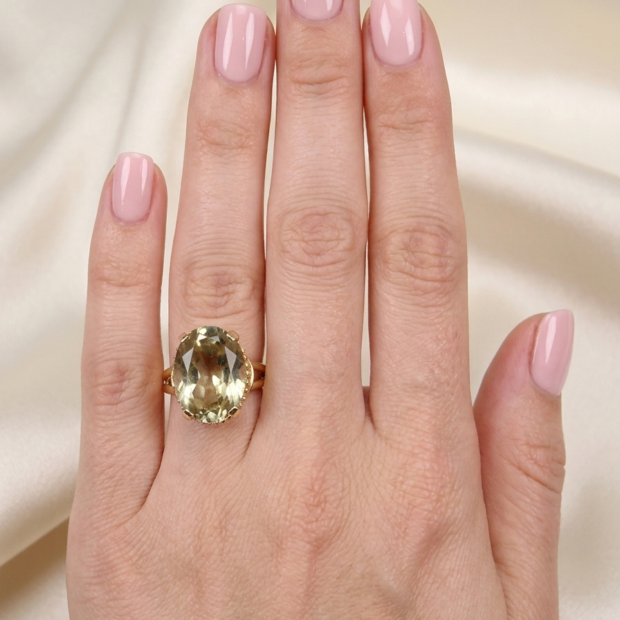 model A continental dress ring that tests as 18 carat gold. Features a large citrine gemstone, that measures 18x13mm, depth 9mm. Golden yellow with a hint of olive green. 