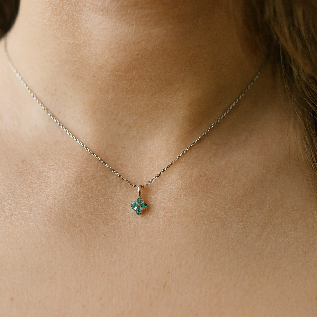 model A delicate pendant crafted in 18ct white gold, featuring a cluster of four round emeralds,