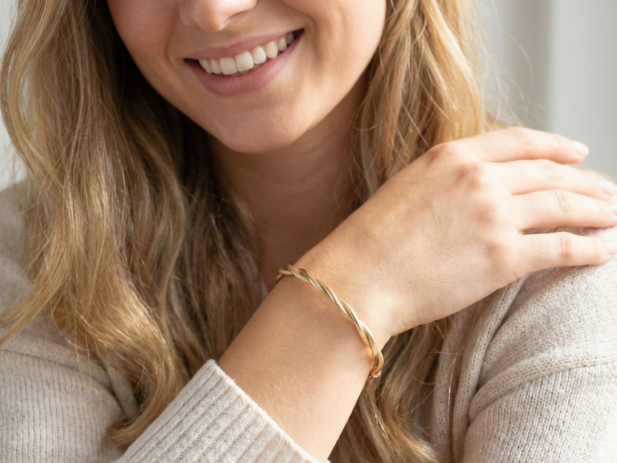 model A double twist of a plain band entwined around a filagree band to add strength and beauty to this very wearable piece of jewellery.