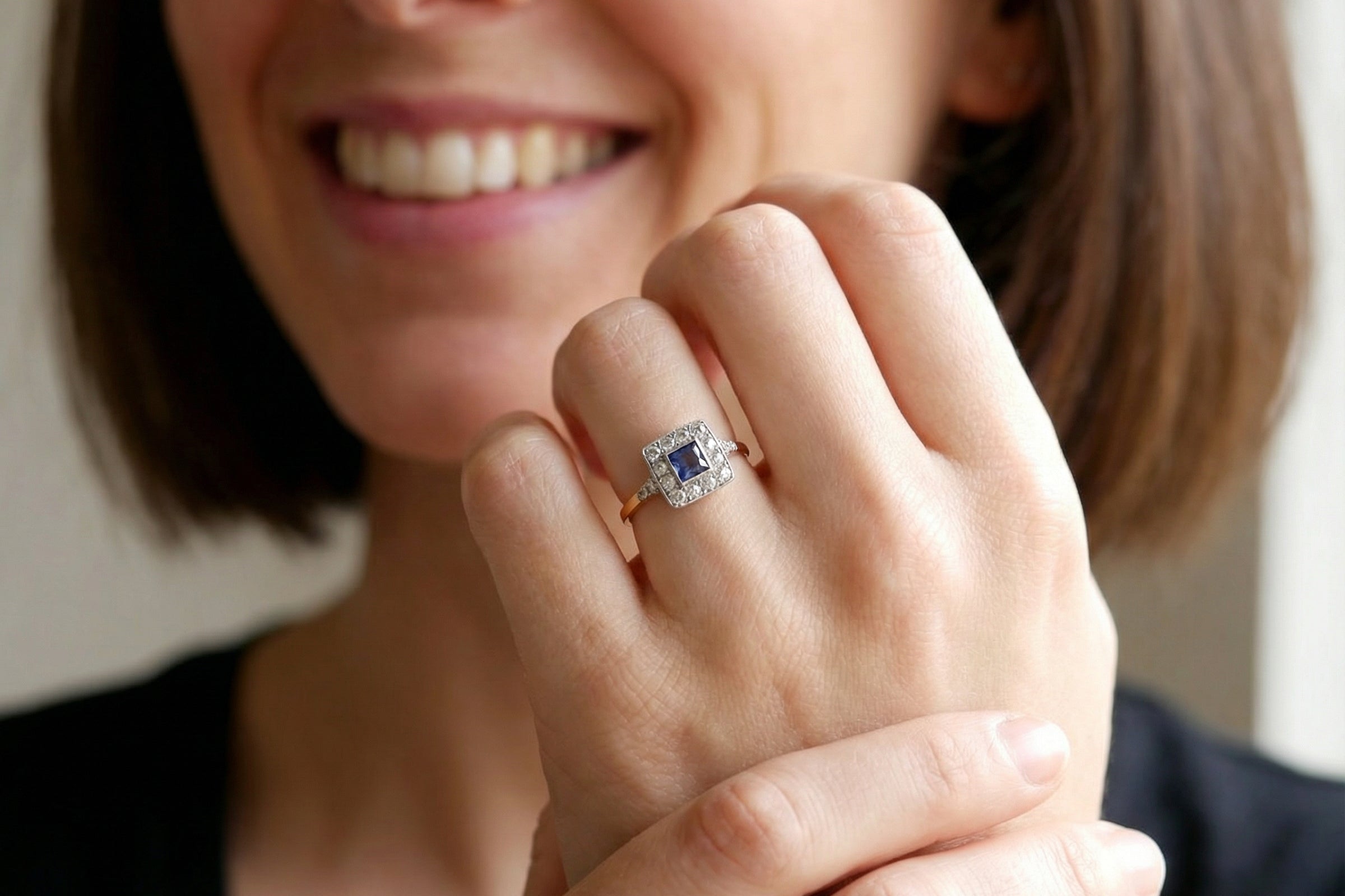model A fine Art Deco cluster ring. The centre stone a square sapphire 5x5mm (est 0.50 carats) in a mille grain setting.