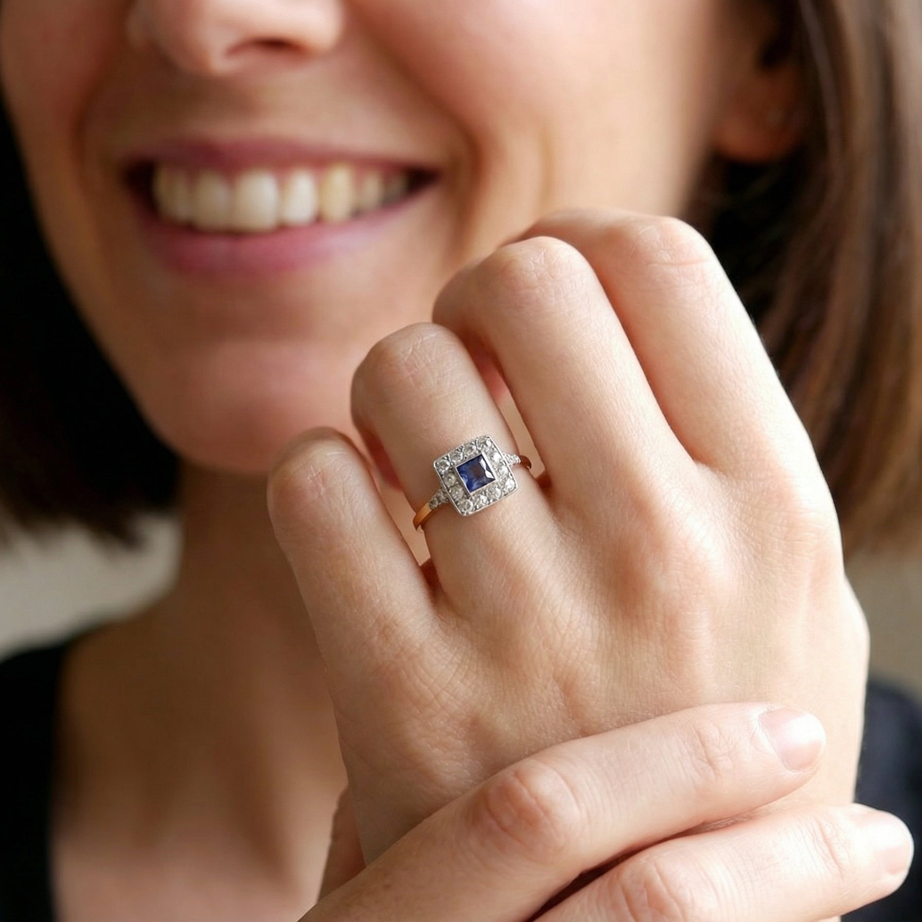 model A fine Art Deco cluster ring. The centre stone a square sapphire 5x5mm (est 0.50 carats) in a mille grain setting.