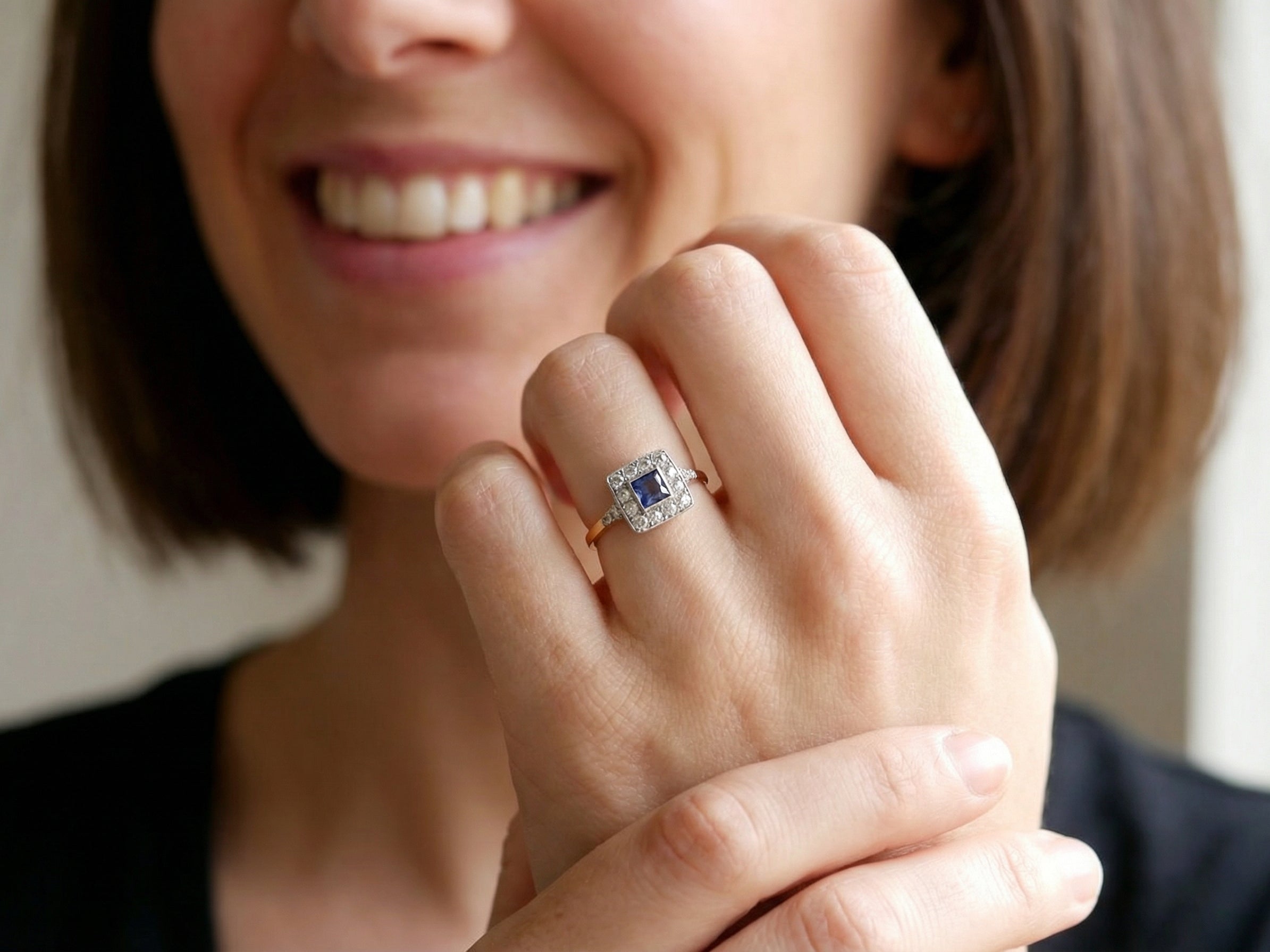 model A fine Art Deco cluster ring. The centre stone a square sapphire 5x5mm (est 0.50 carats) in a mille grain setting.