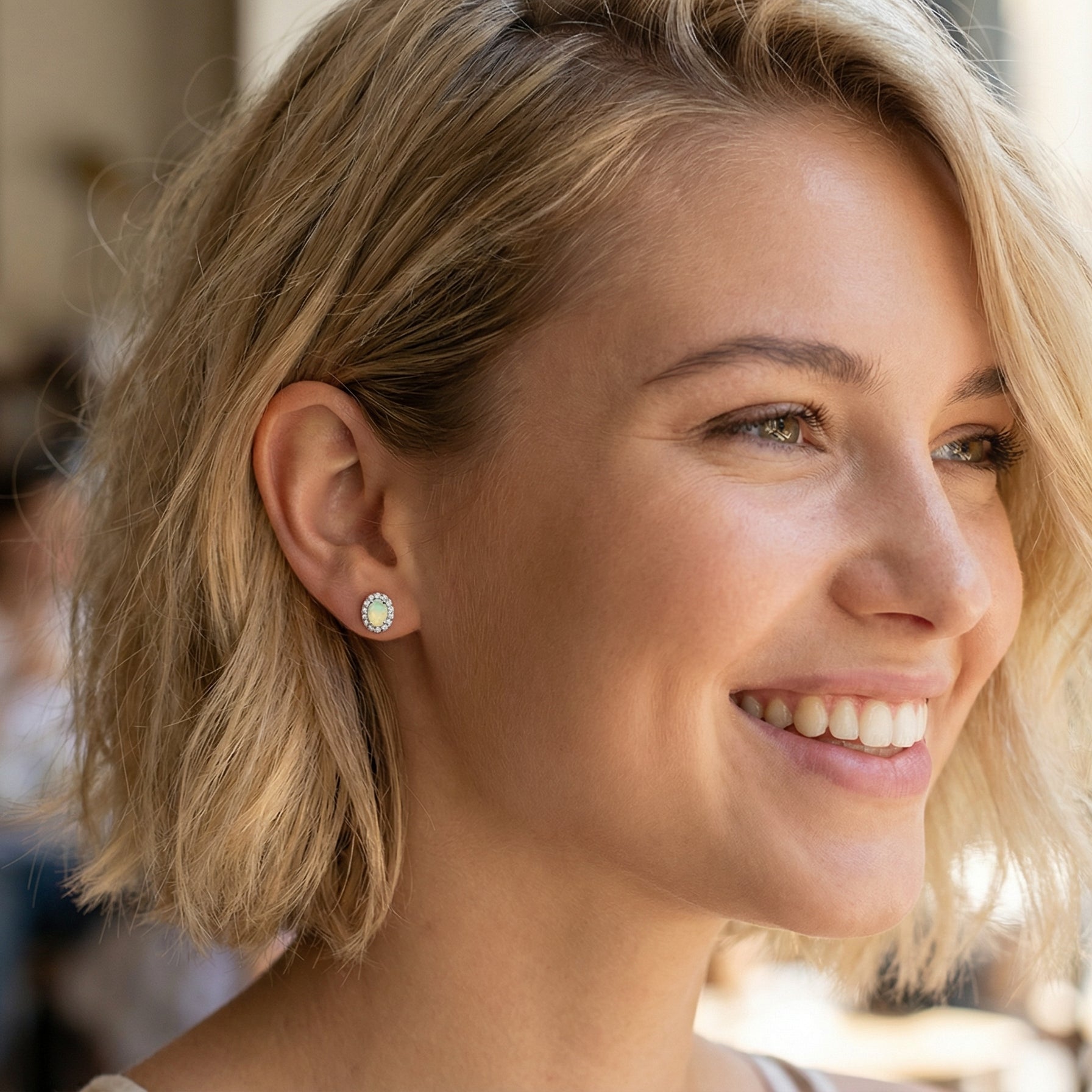 model A fine and elegant pair of platinum* stud earrings, each beautifully set with an exceptional white opal measuring 7 x 5mm. T