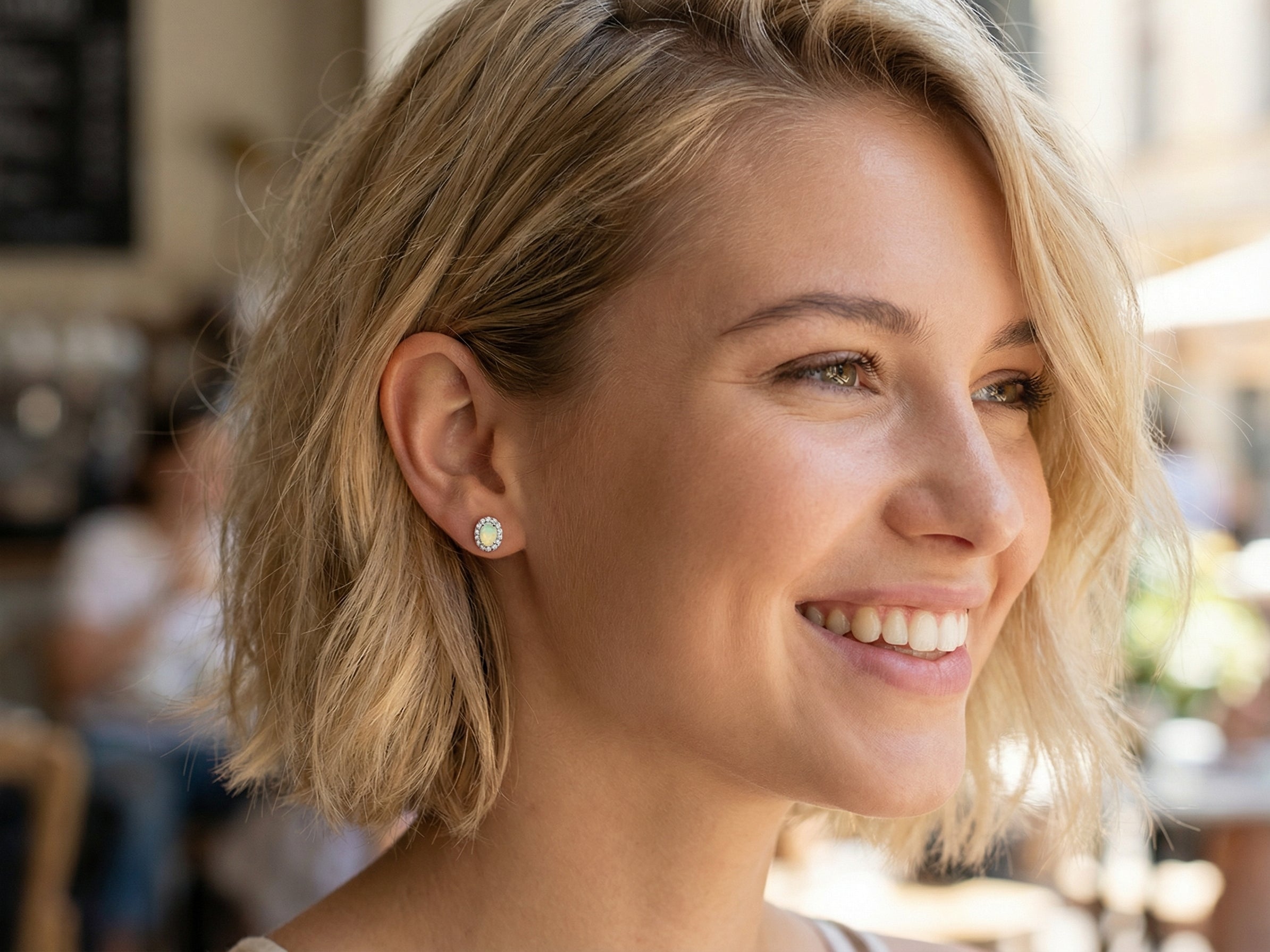 model A fine and elegant pair of platinum* stud earrings, each beautifully set with an exceptional white opal measuring 7 x 5mm. T