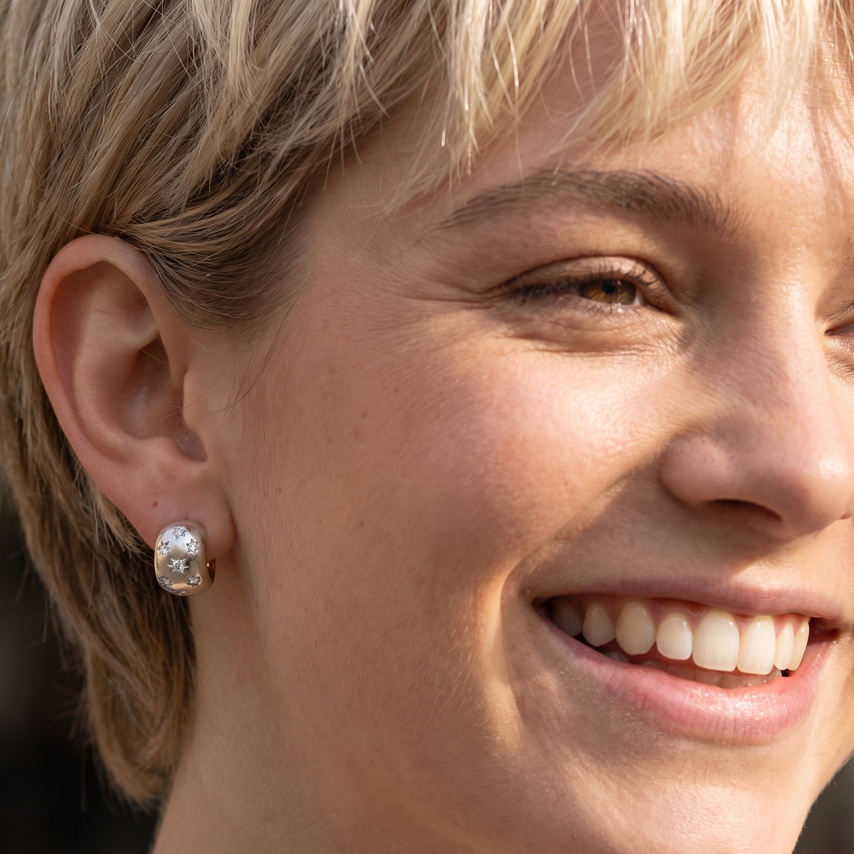 model A fine pair of cuff style hoop earrings. The front part is 18 carat white gold * set with seven small white diamonds, e