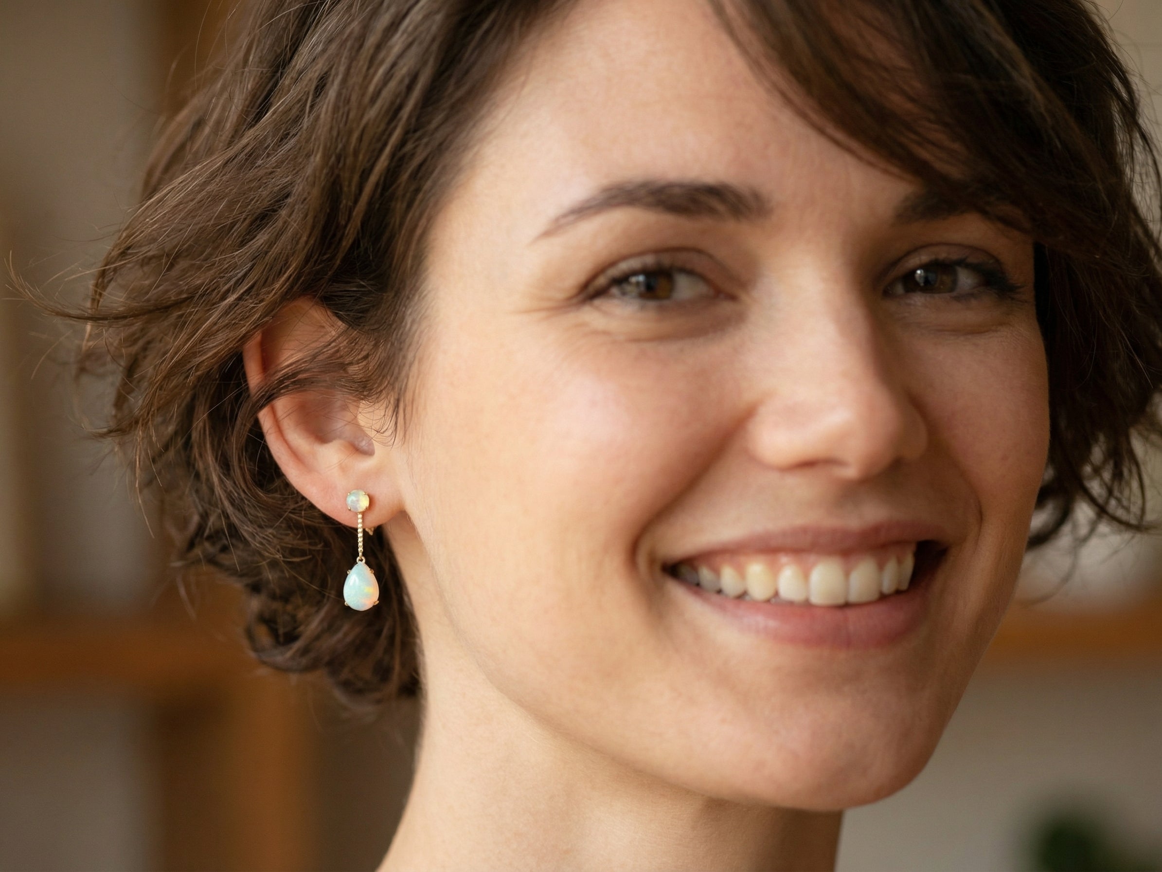 model A fine pair of drop earrings. Suspending from a round opal which is at the head of the post, (measures 4mm) a pear shaped opal 8x6mm, and attached to a 9mm box link chain.
