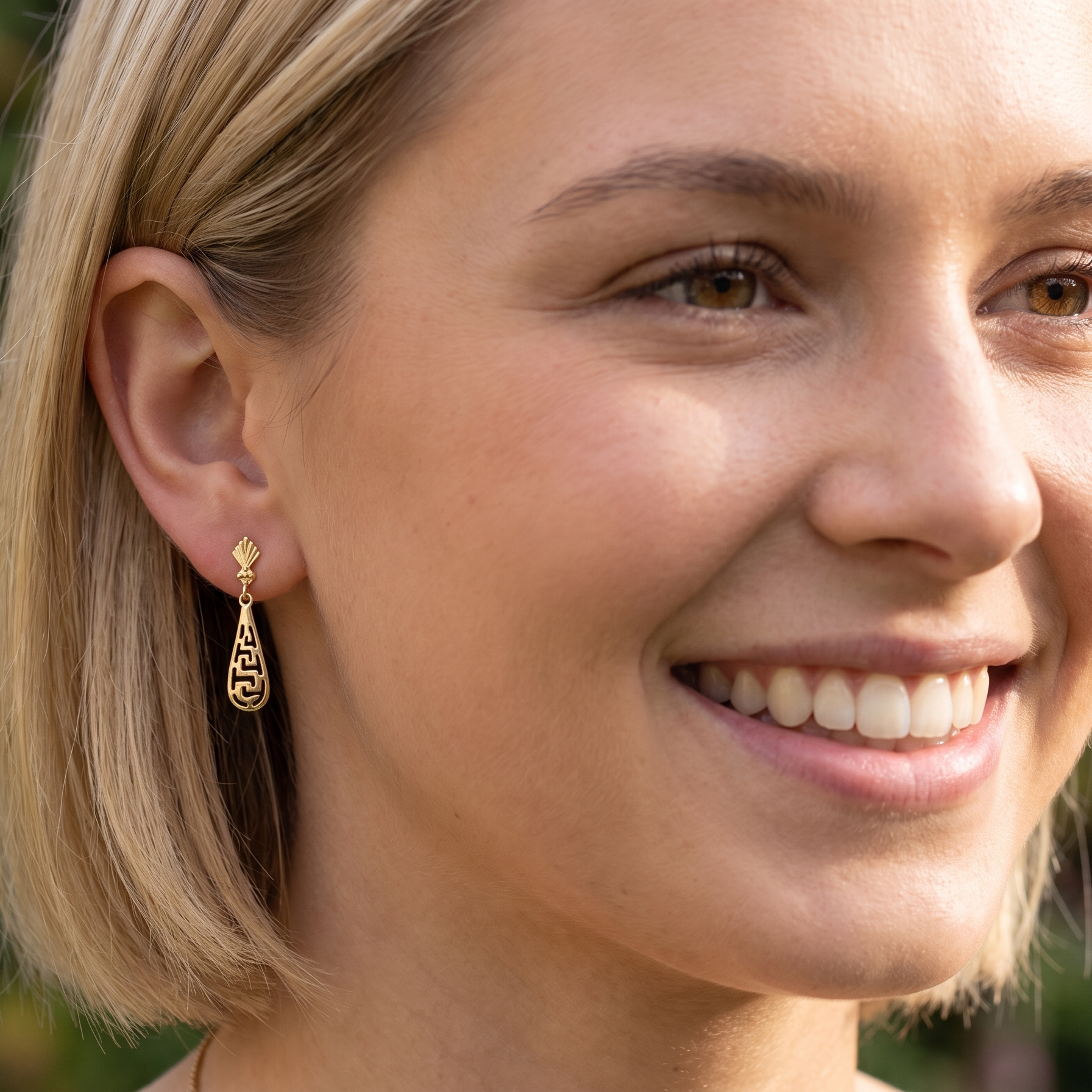 model A pair of 9 carat gold drop earrings. Each measures 25x10mm, celtic style