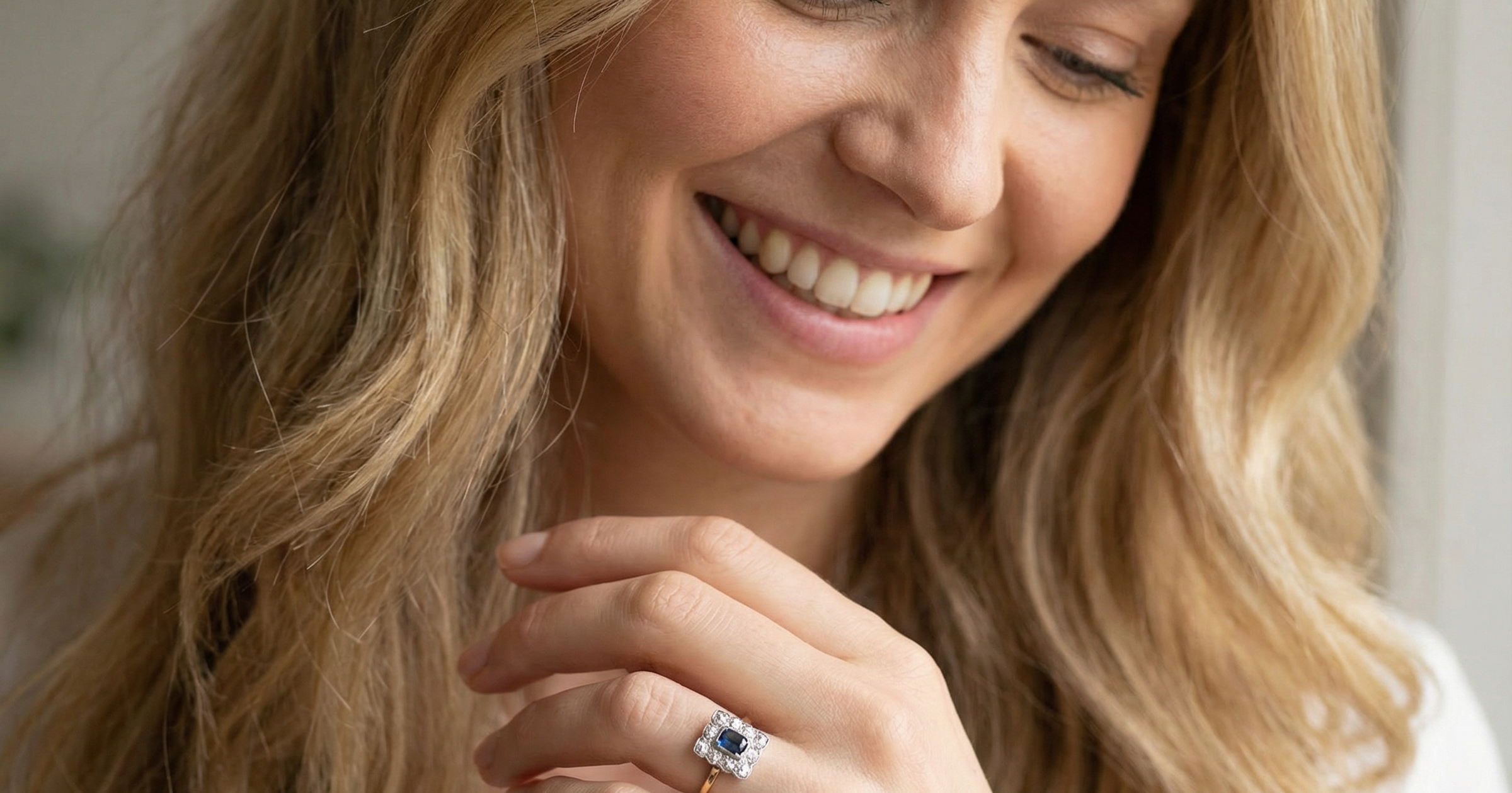 model A rectangular cluster ring that features in its centre a cushion shaped dark blue sapphire, that measures 5x3.5mm (est 0.30 carats)