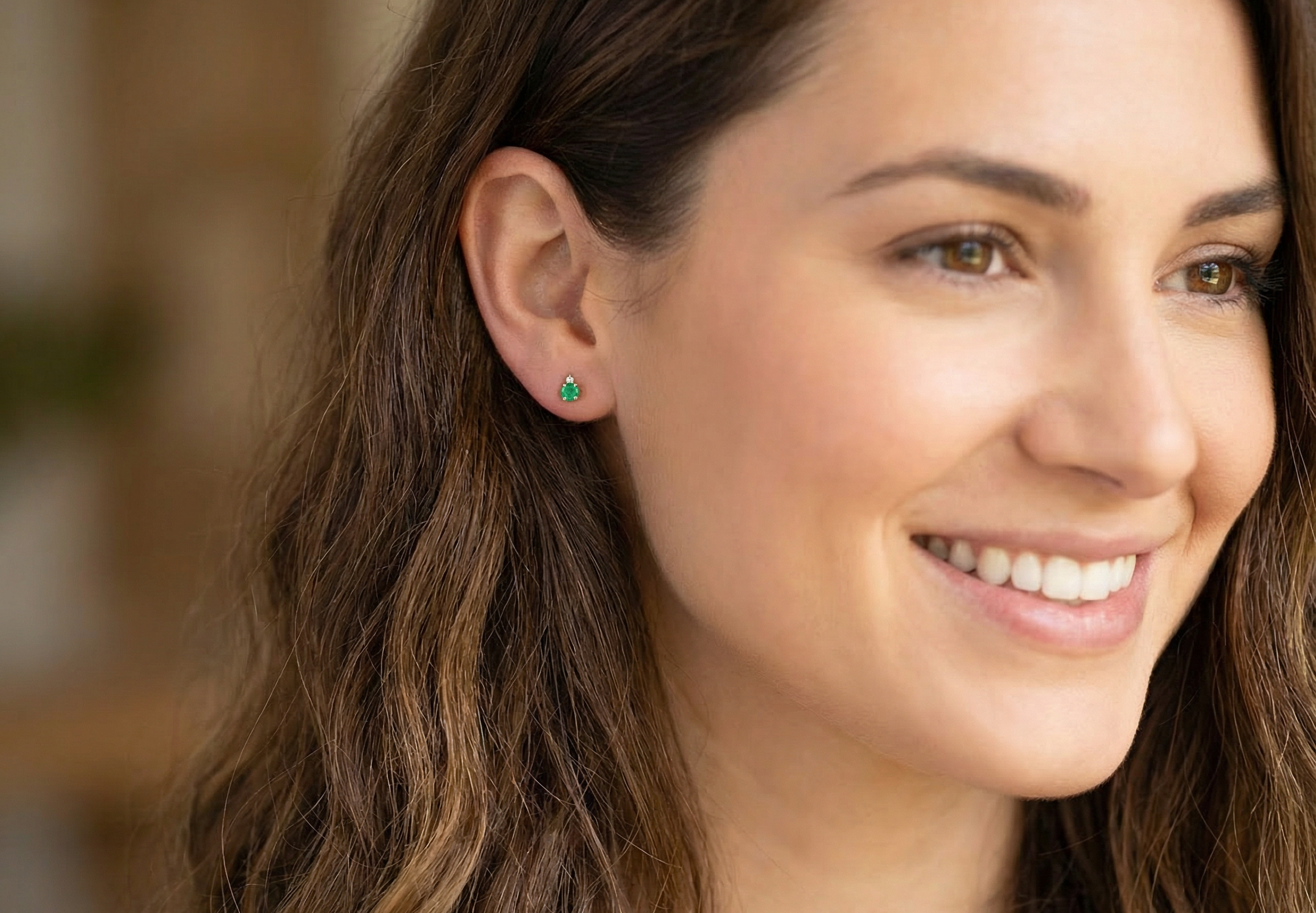 model A simple pair of 9 carat gold stud earrings. emerald and diamond
