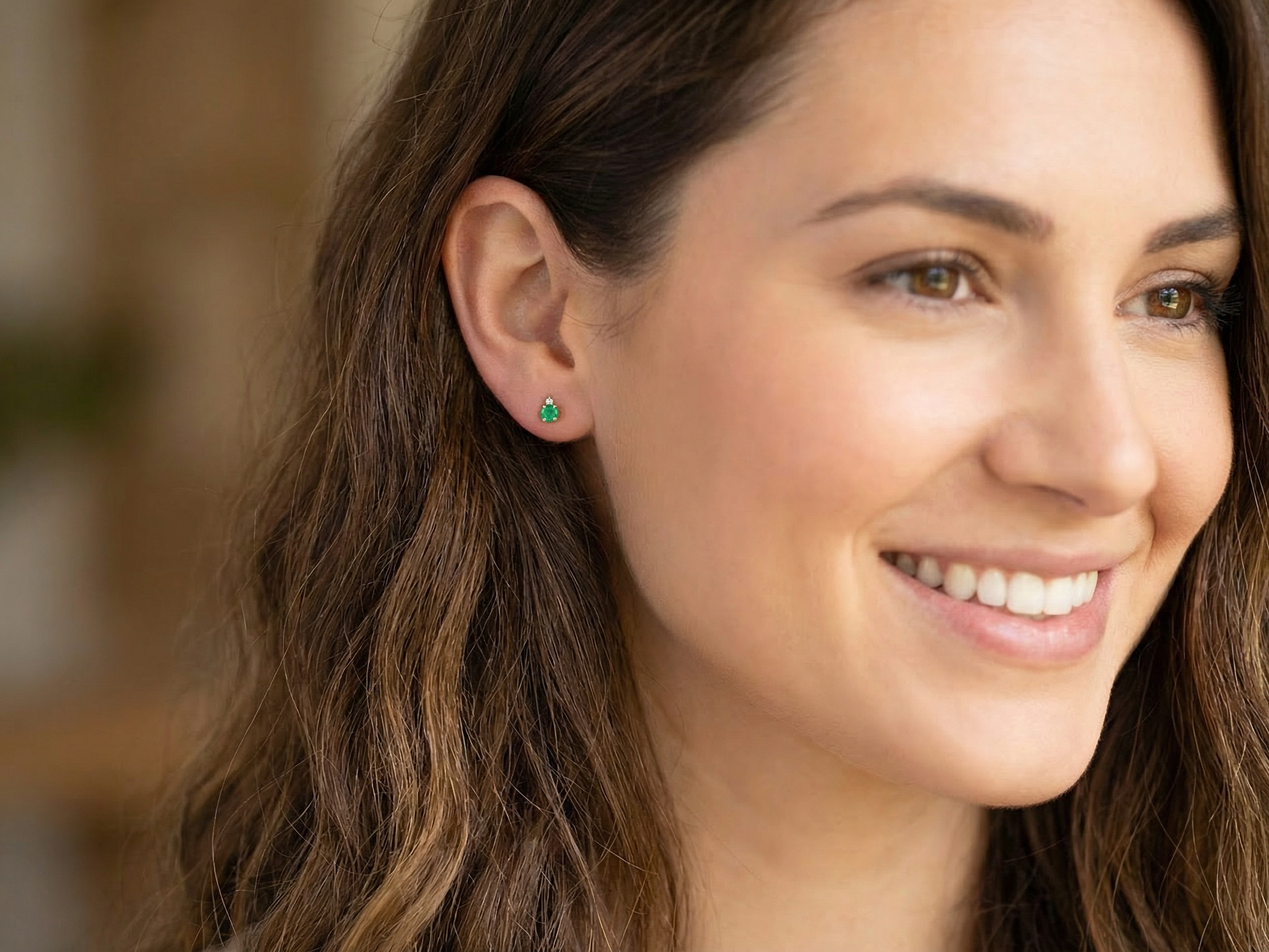 model A simple pair of 9 carat gold stud earrings. emerald and diamond