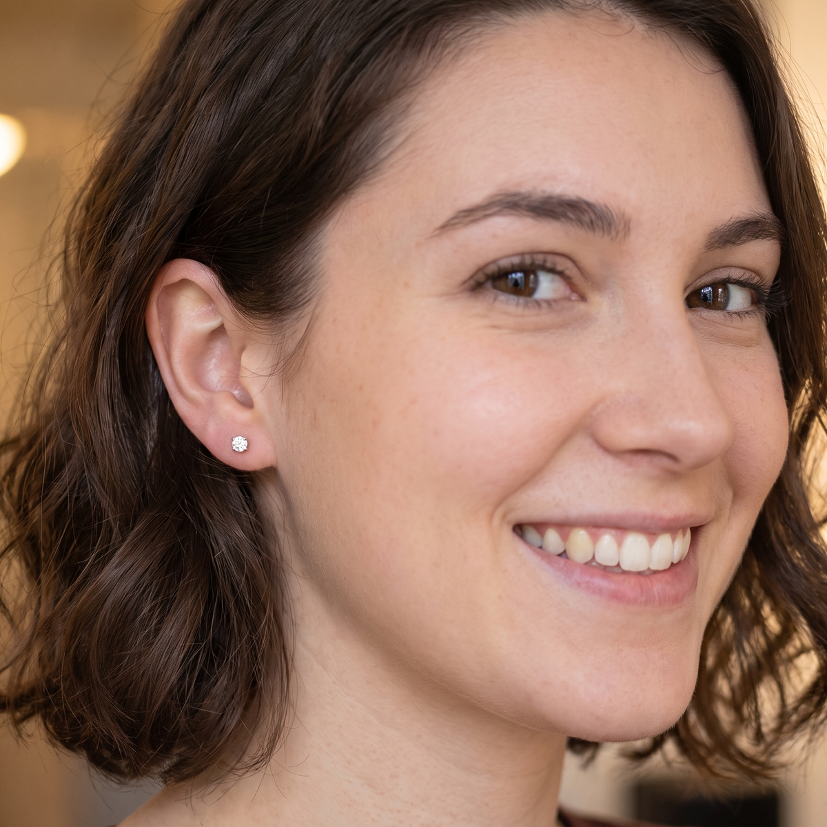 model A stunning pair of classic diamond solitaire stud earrings, beautifully crafted in 18 carat white gold and featuring two sparkling brilliant cut white diamonds.