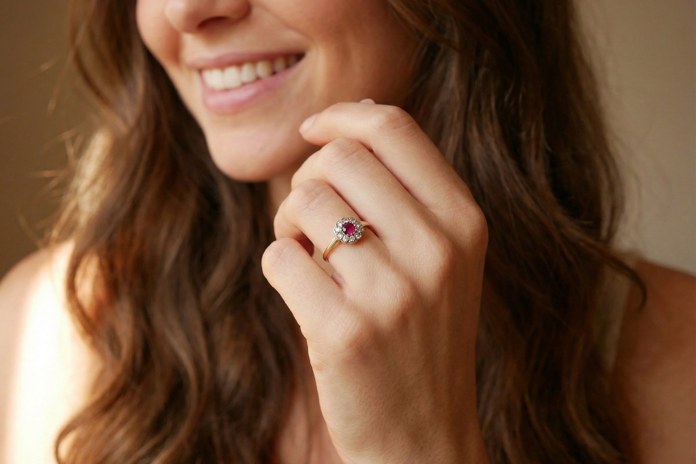 model A very pretty vintage daisy cluster ring. Features to the centre a round pink red ruby that measures 4mm, and is mille grain set.