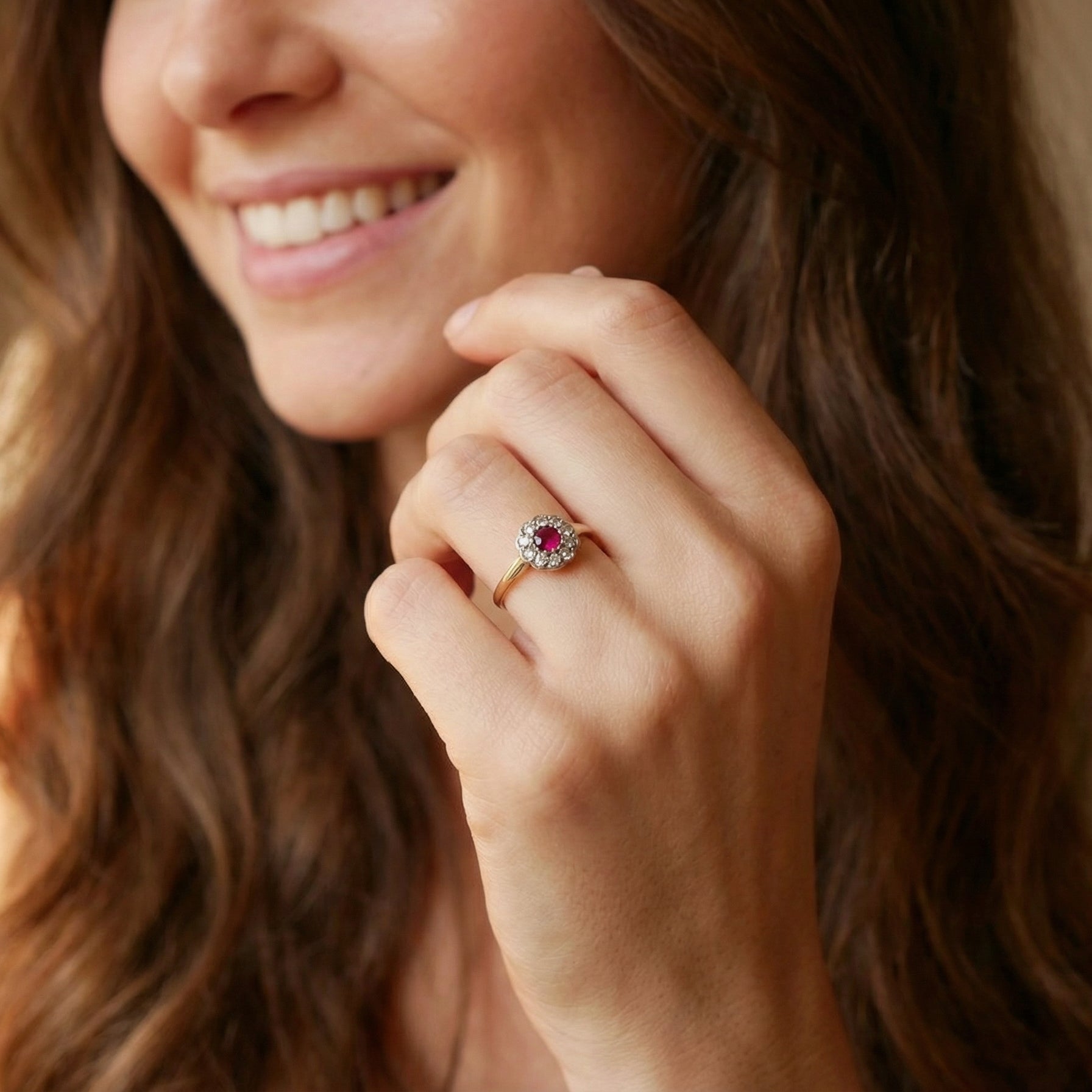 model A very pretty vintage daisy cluster ring. Features to the centre a round pink red ruby that measures 4mm, and is mille grain set.
