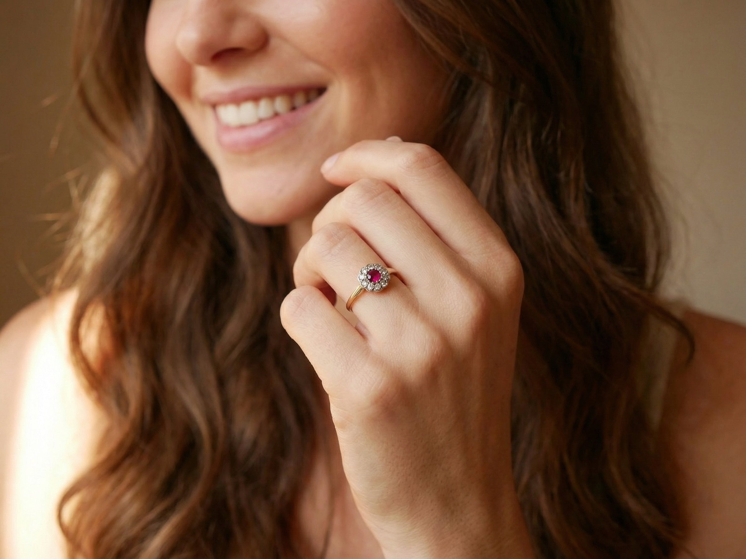 model A very pretty vintage daisy cluster ring. Features to the centre a round pink red ruby that measures 4mm, and is mille grain set.