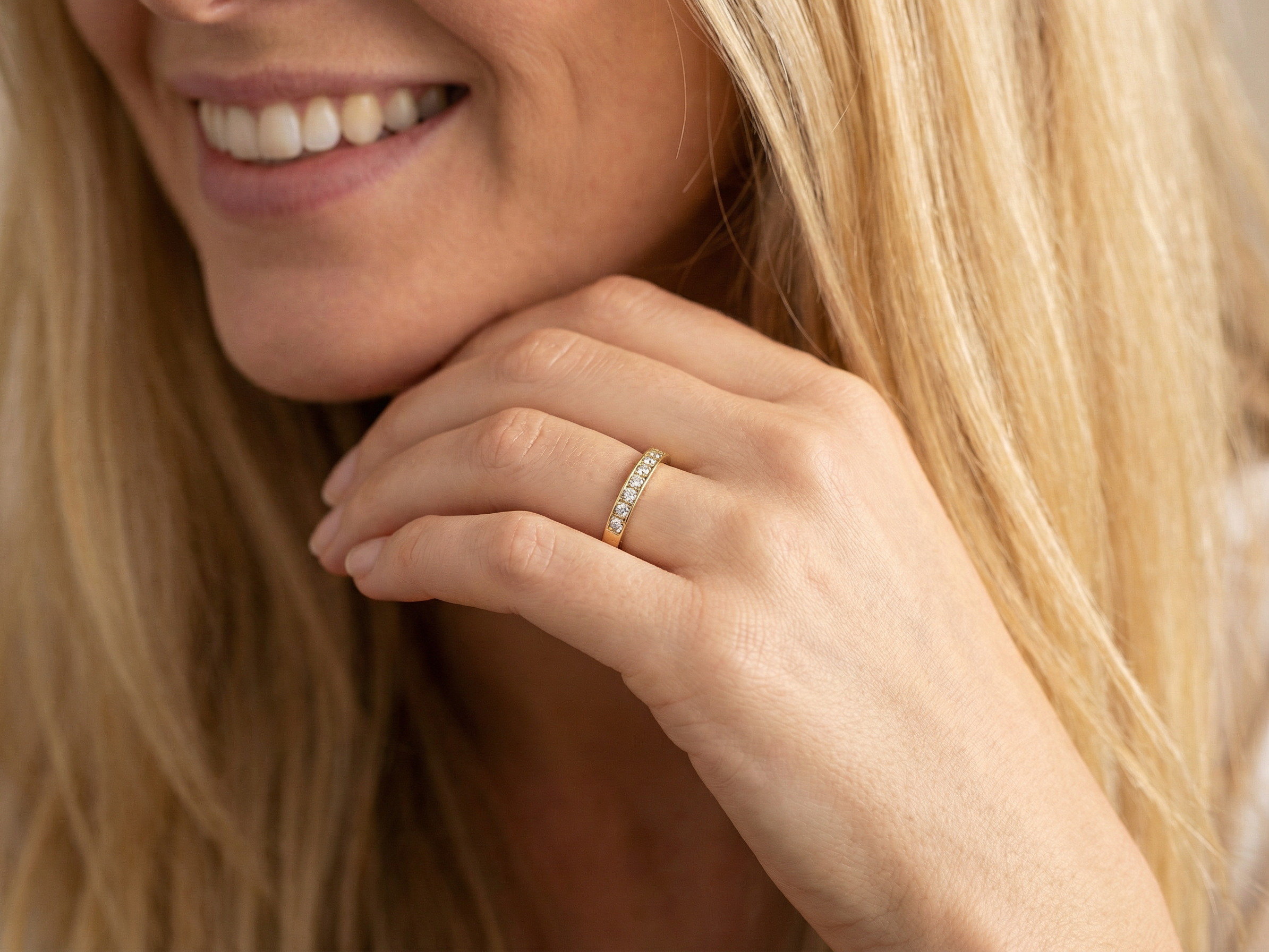 model An 18 carat gold half-hoop eternity ring, set with eight brilliant-cut white diamonds