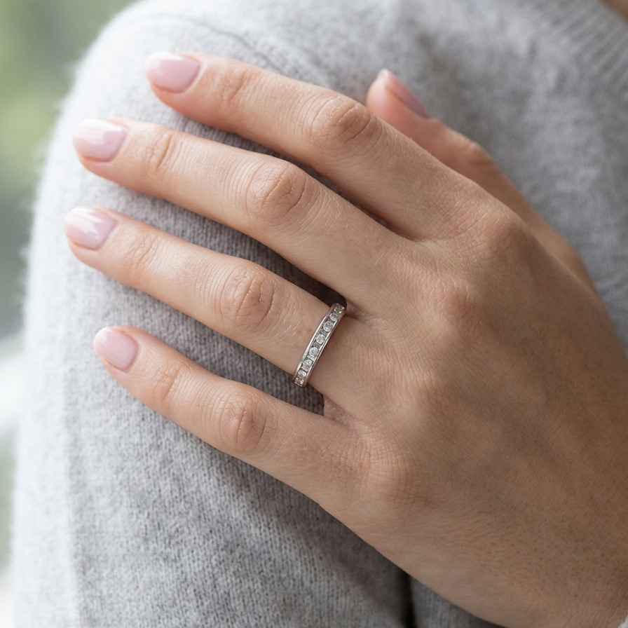 model An 18 carat white gold half hoop eternity ring. Mixed cuts of white diamonds which consist of seven round brilliant stones, each 2mm diameter and eight baguette cut stones, each 2x1.5mm. Estimated total 0.50 carats.