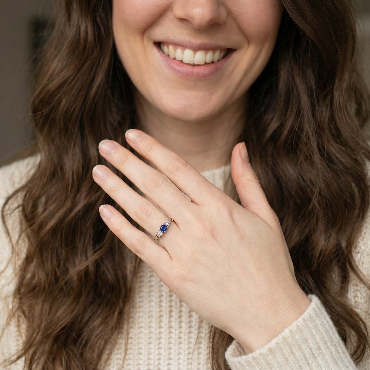 model An early 20th century engagement ring. The centre stone a dark blue sapphire