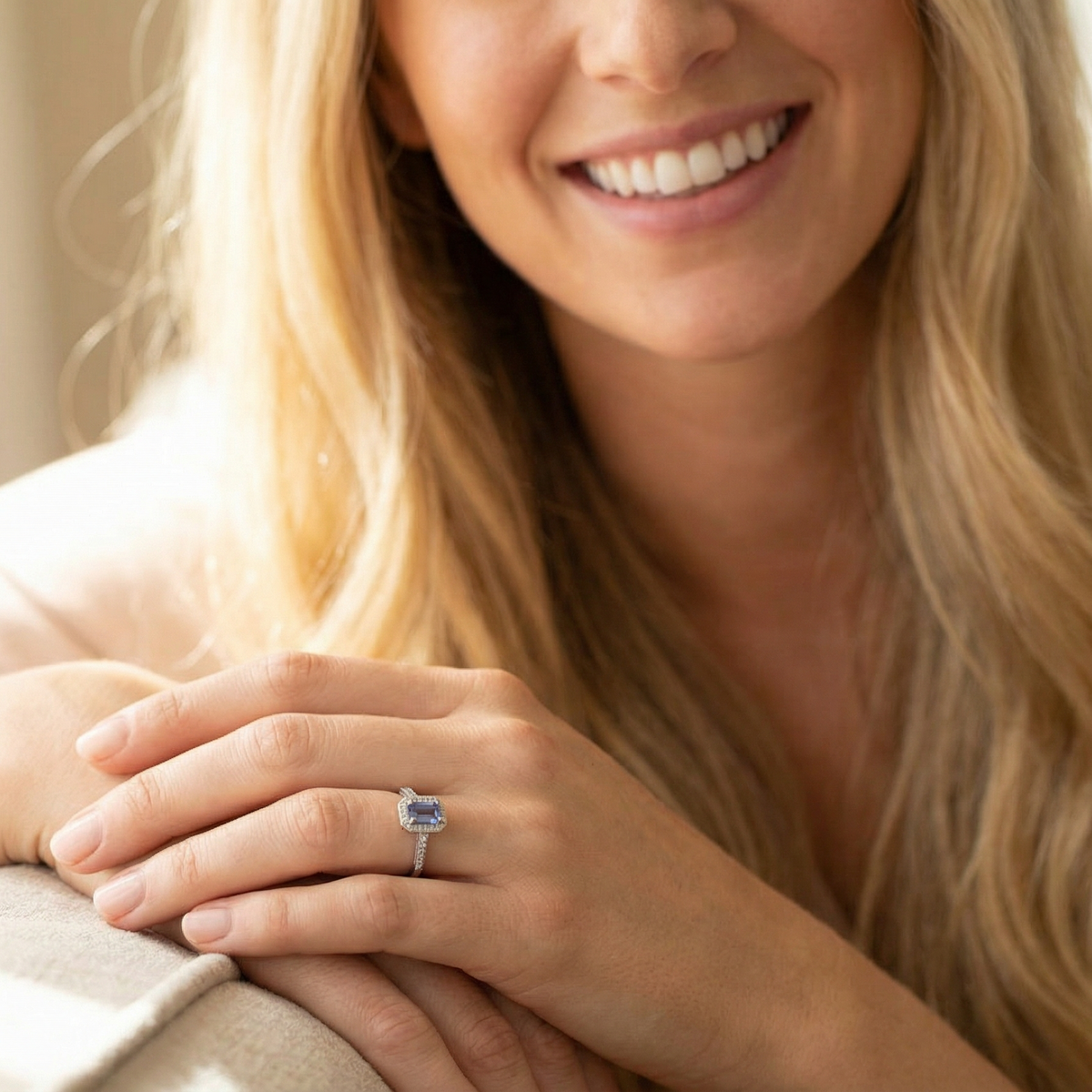 model An elegant cluster ring that features to the centre a rectangular tanzanite gemstone that measures 6x4mm (est 0.50 carats) AAA colour.