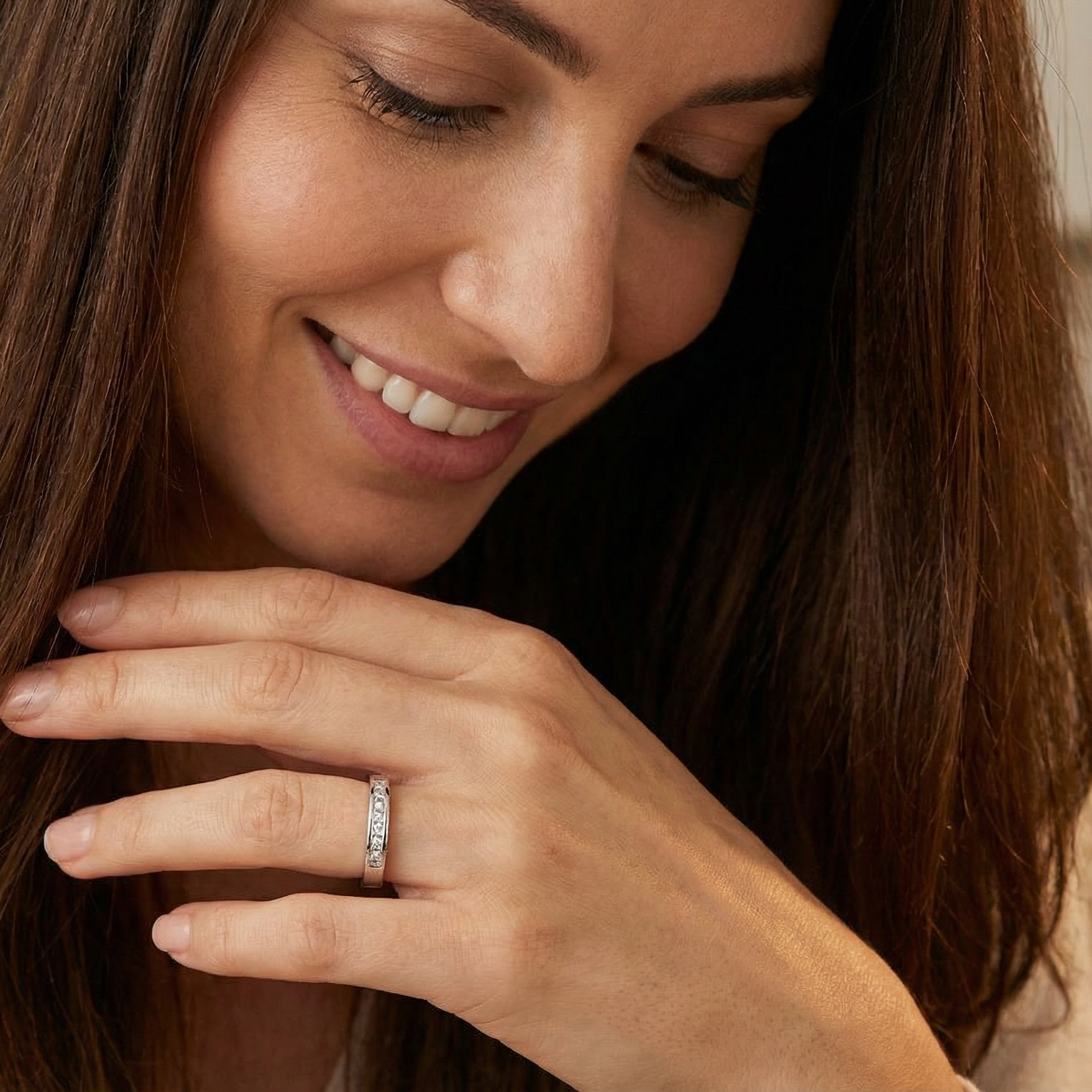 model An elegant half-hoop eternity ring set with nine princess-cut white diamonds, each measuring approximately 2.5mm, with a total estimated diamond weight of 0.90 carats.