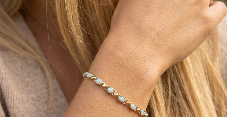 model An elegant line bracelet set with fourteen oval opals, each measuring approximately 5 x 3 mm, displaying a pleasing and lively play of colour.