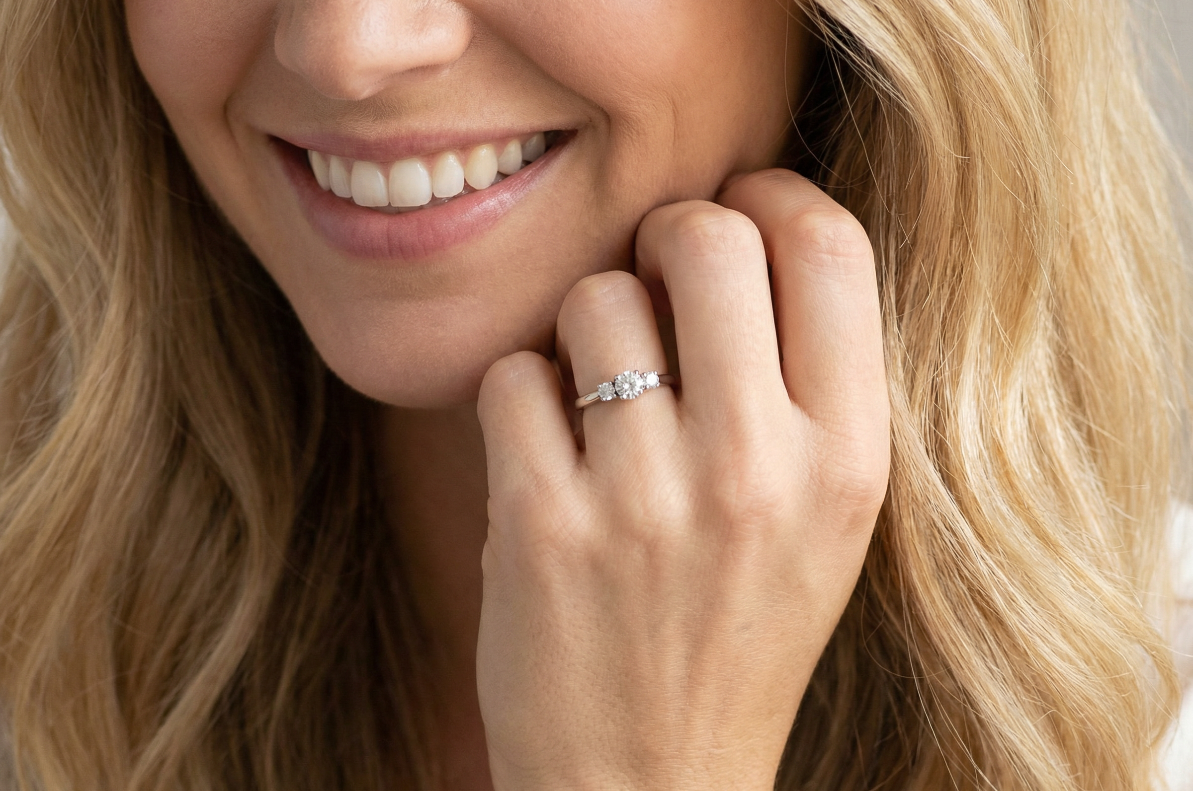 model An elegant trilogy ring set with three brilliant-cut white diamonds,