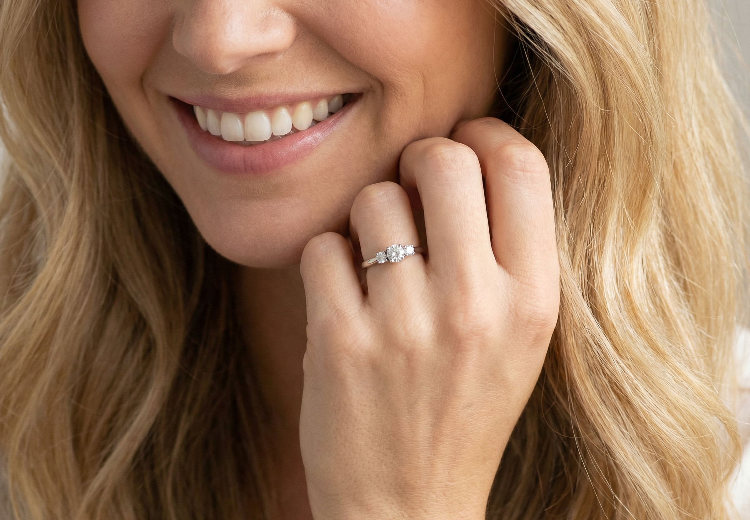 model An elegant trilogy ring set with three brilliant-cut white diamonds,