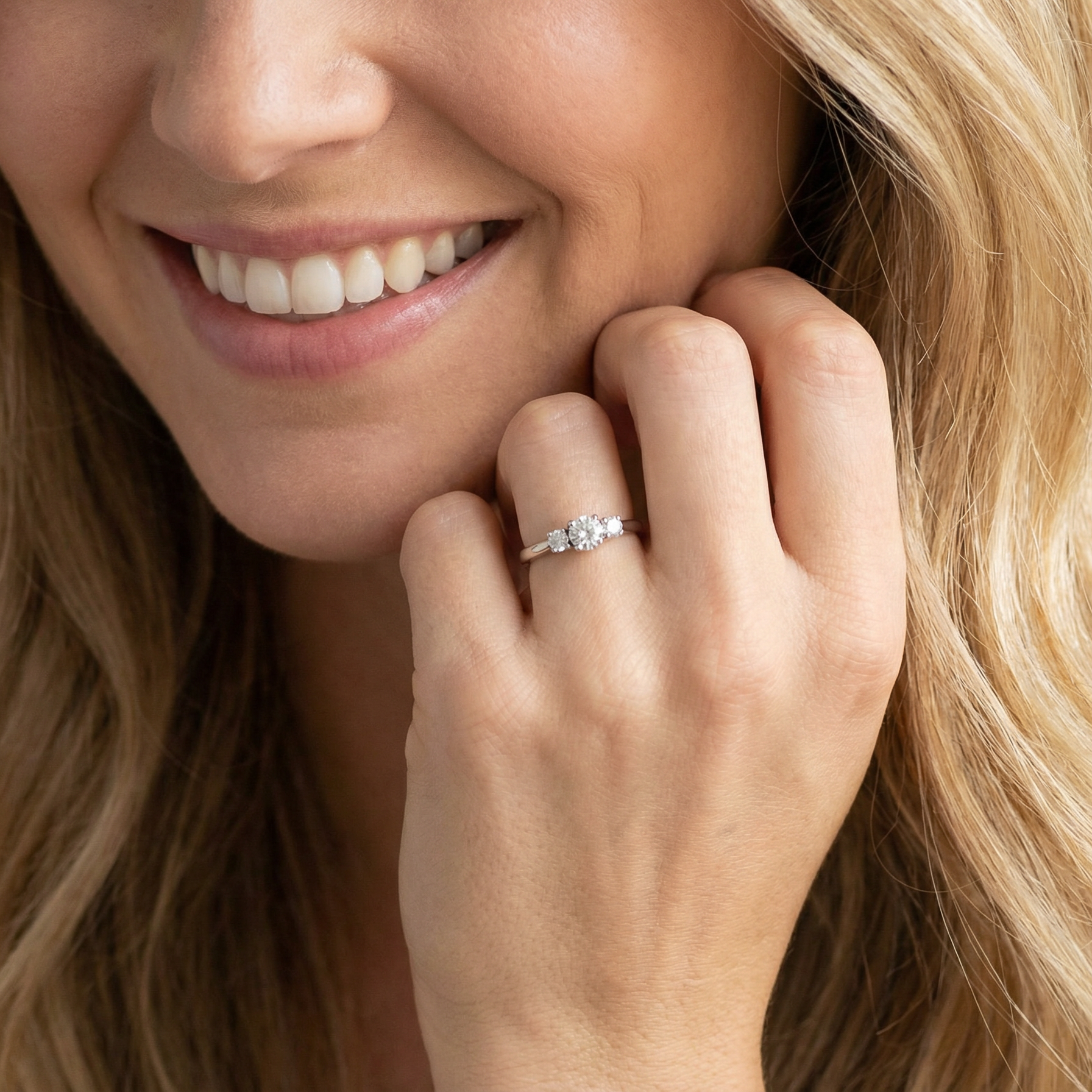 model An elegant trilogy ring set with three brilliant-cut white diamonds,