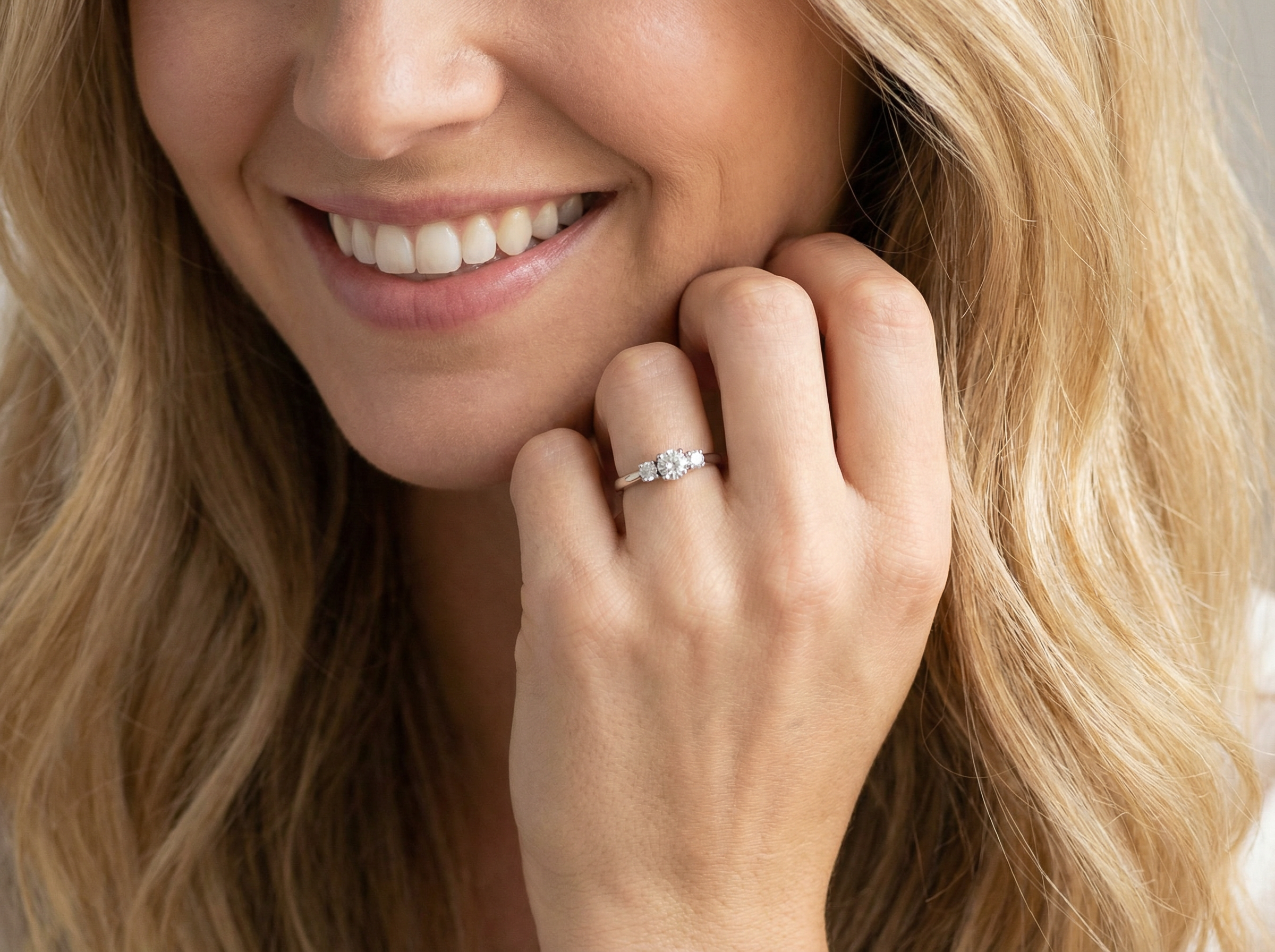 model An elegant trilogy ring set with three brilliant-cut white diamonds,