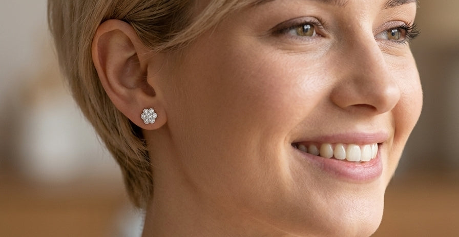 model The diamonds measure approximately 2.6mm each, with an estimated total diamond weight of 0.40ct per earring (0.80ct total). Assessed as colour I–J and clarity SI.
The elegant daisy-style heads measure 9.3mm