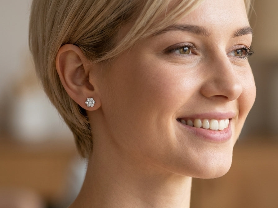 model The diamonds measure approximately 2.6mm each, with an estimated total diamond weight of 0.40ct per earring (0.80ct total). Assessed as colour I–J and clarity SI.
The elegant daisy-style heads measure 9.3mm