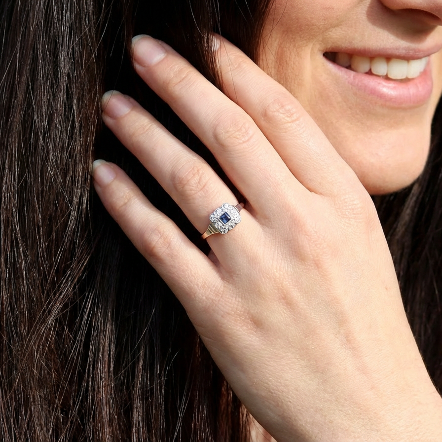 model antique cluster ring. Features a small square sapphire