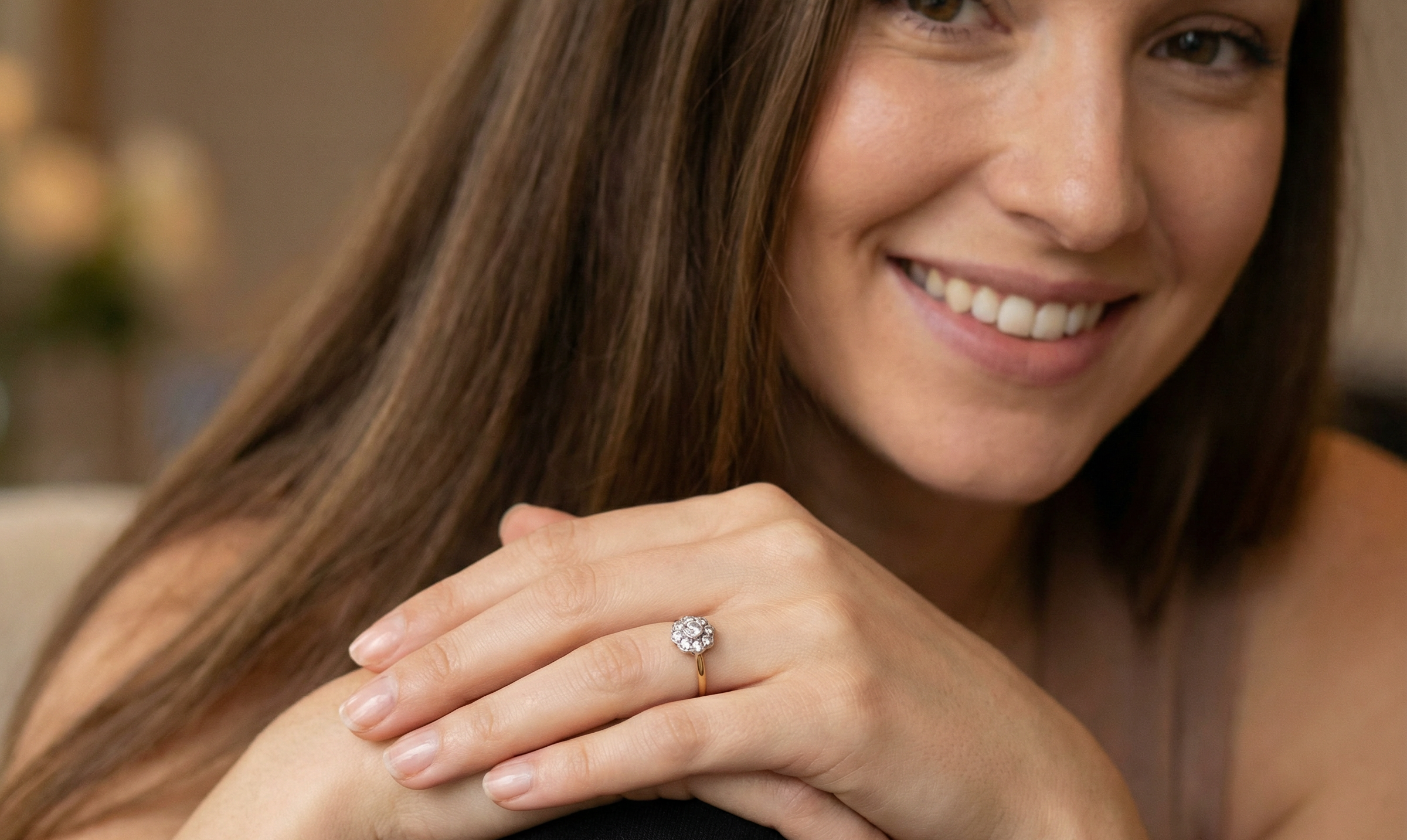model early 20th-century vintage diamond cluster ring, featuring a classic daisy-shaped head set with nine old brilliant-cut white diamonds.