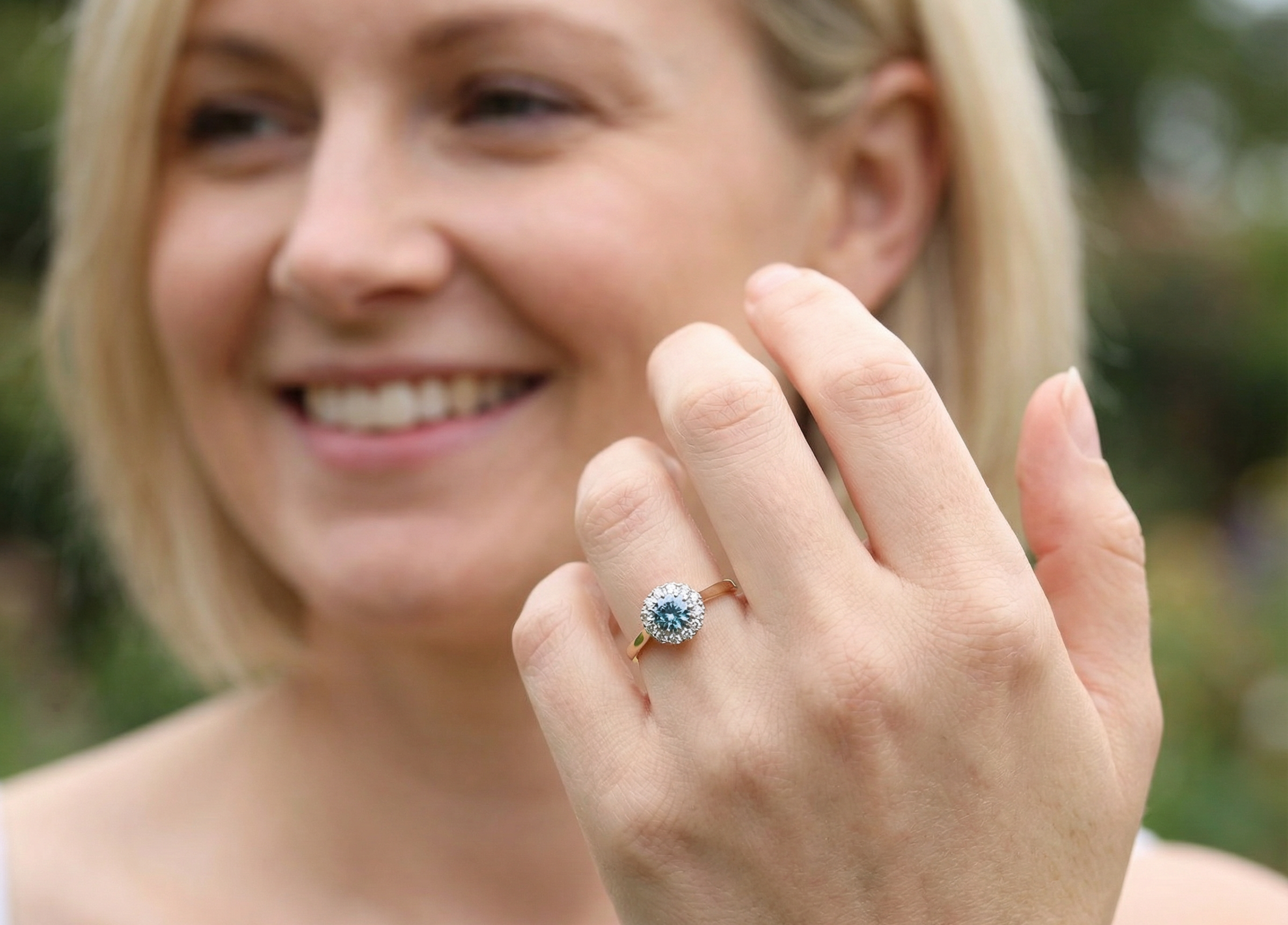 model fine vintage cluster ring. The centre stone a natural blue zircon, 7mm diameter, bright sparkling refraction to the sky blue hue. 