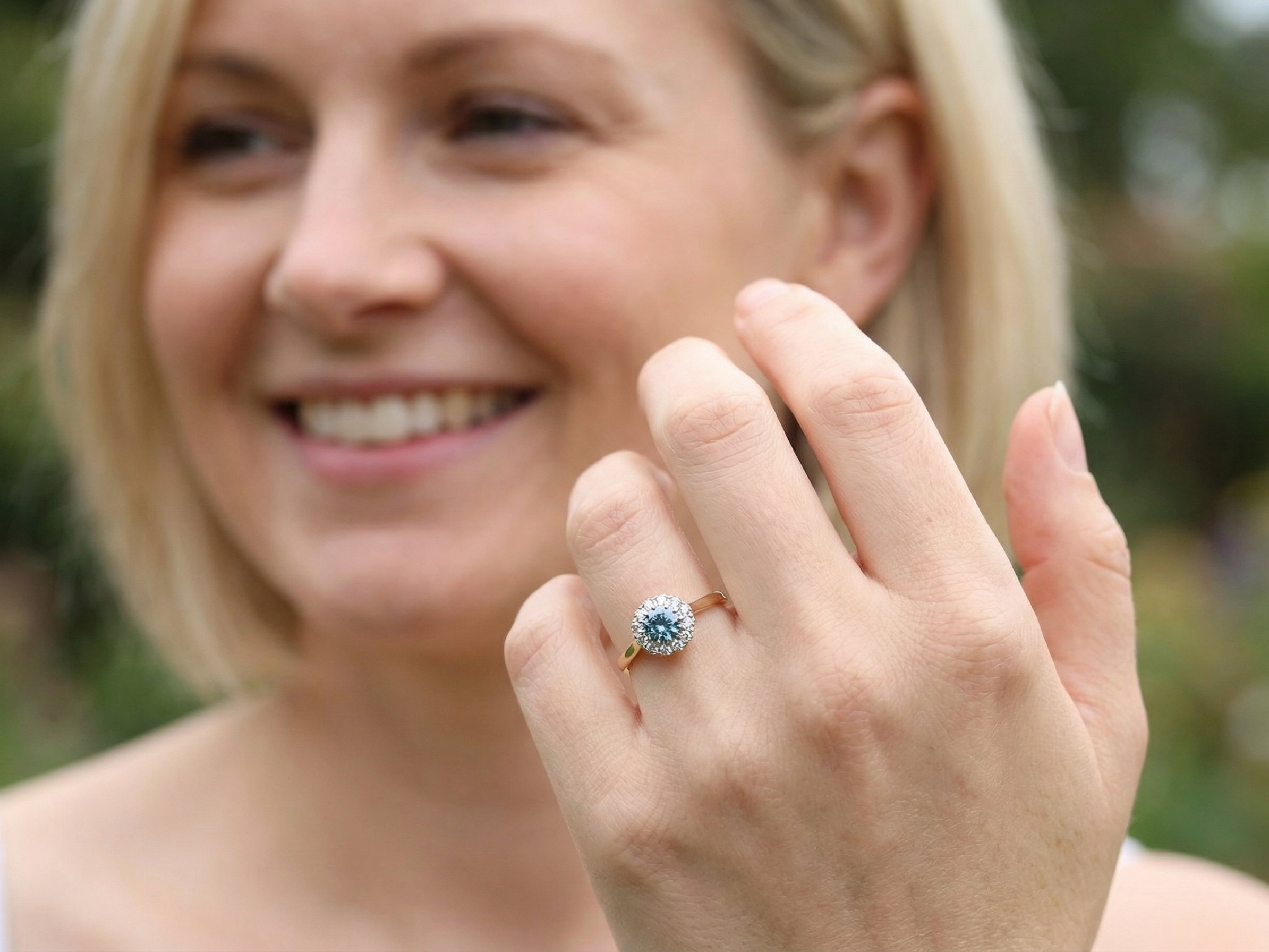 model fine vintage cluster ring. The centre stone a natural blue zircon, 7mm diameter, bright sparkling refraction to the sky blue hue. 