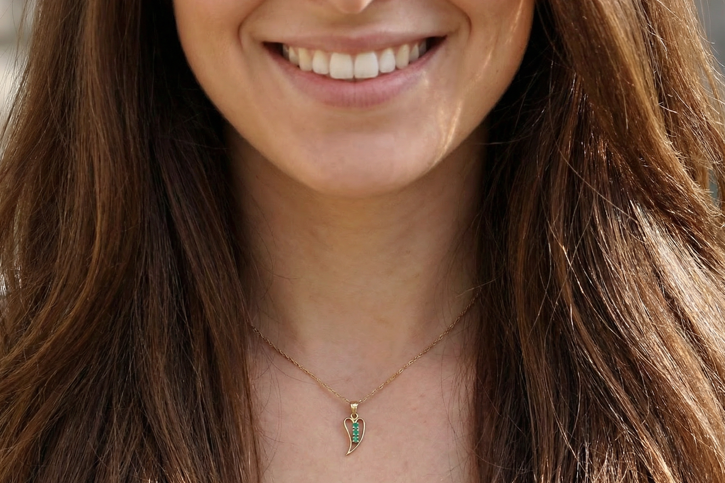 open-heart pendant, beautifully set with three emeralds, model