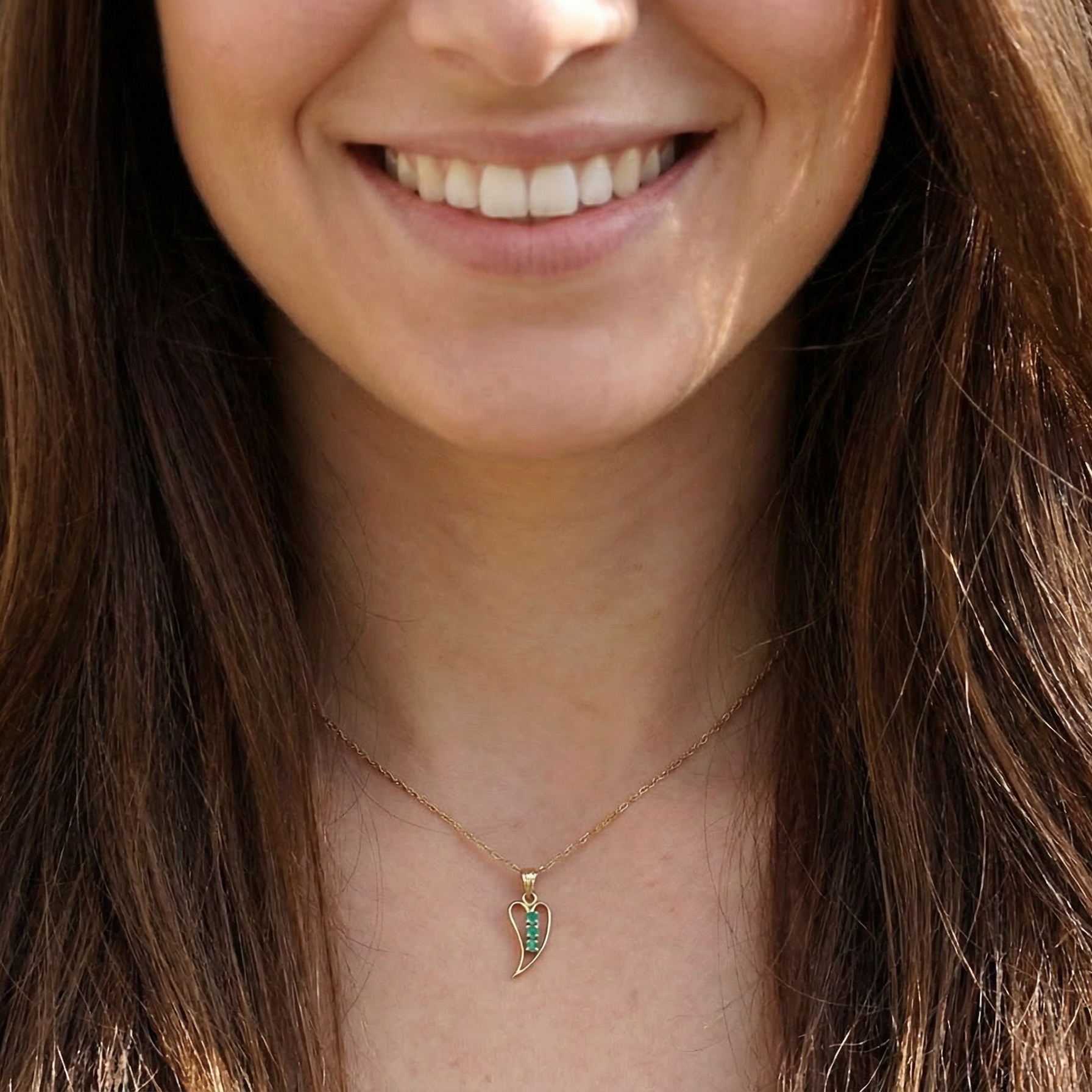 open-heart pendant, beautifully set with three emeralds, model