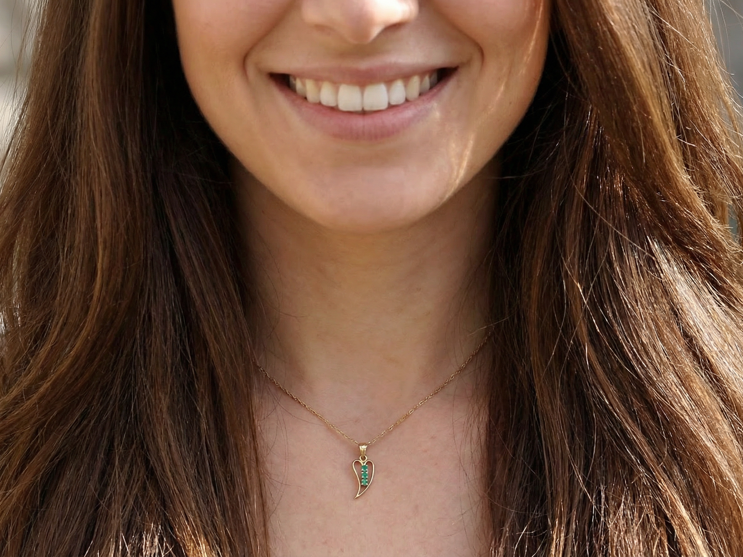 open-heart pendant, beautifully set with three emeralds, model