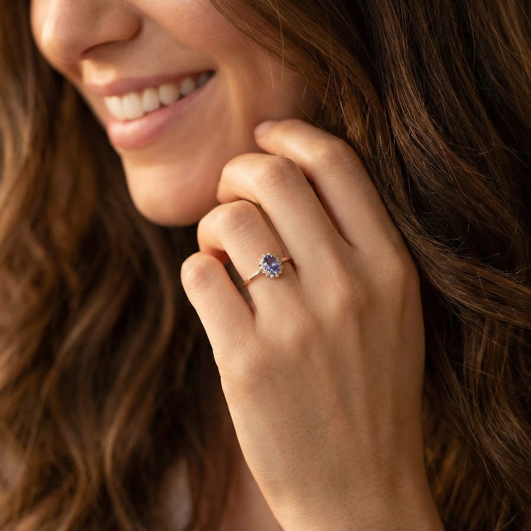 model pretty cluster ring that features an oval cut tanzanite gemstone,