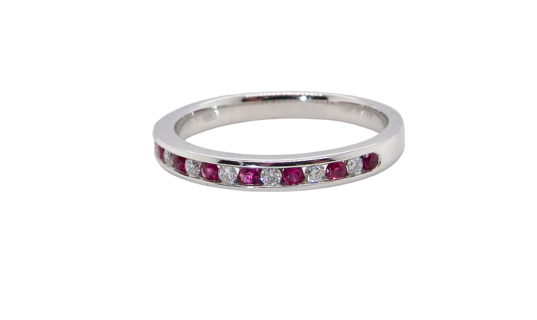 new A white gold half hoop eternity ring. Set with seven round rubies and six brilliant cut white diamonds